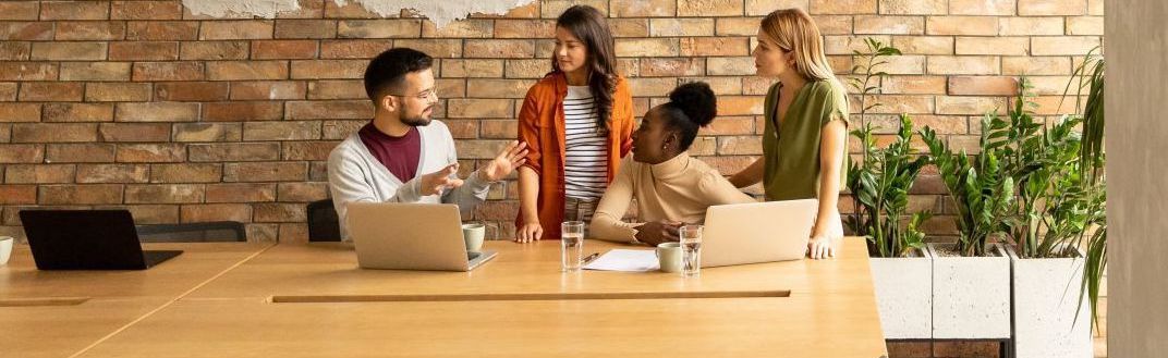 Group of people discussing work at a conference table
